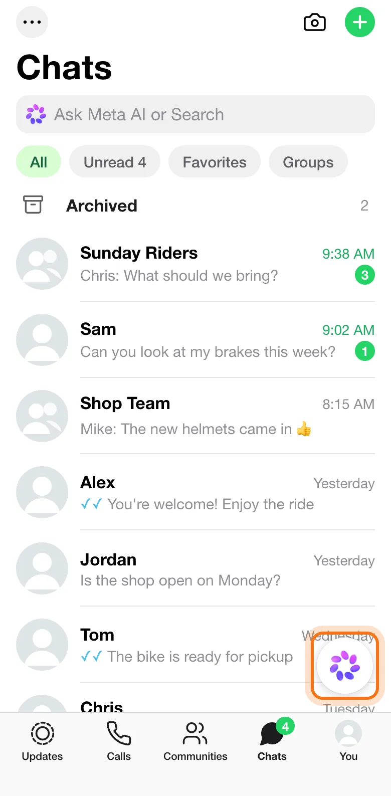 WhatsApp's Chats tab on an iPhone, with the round Meta AI button above the tabs marked, and the "Ask Meta AI or Search" bar at the top.